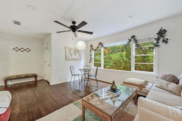 living room with ceiling fan and dark hardwood / wood-style flooring