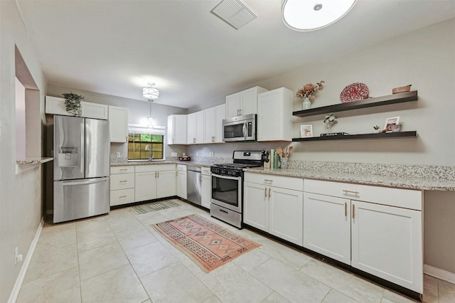 4025 Valley View Rd Unit 2, Austin, TX 78704 - kitchen featuring stainless steel appliances, white cabinetry, light stone countertops, and open shelves