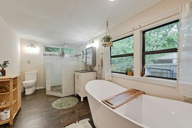 4025 Valley View Rd Unit 2, Austin, TX 78704 - bathroom featuring vanity, a walk in shower, wood finished floors, and a soaking tub