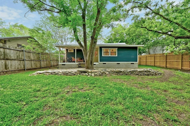 rear view of house with a patio and a lawn