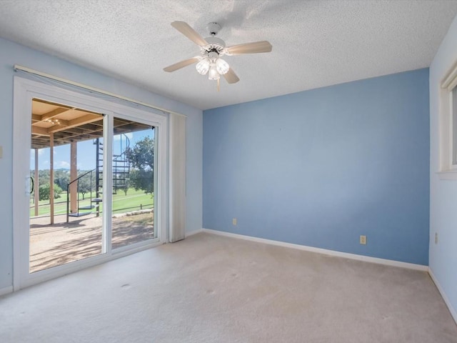 unfurnished room with ceiling fan, light colored carpet, and a textured ceiling