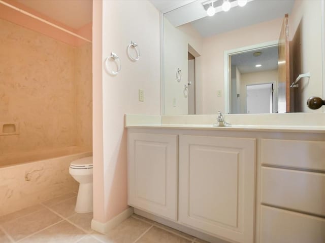 full bathroom with washtub / shower combination, vanity, toilet, and tile patterned flooring