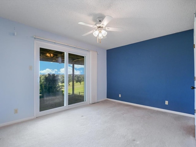 unfurnished room with ceiling fan, carpet floors, and a textured ceiling