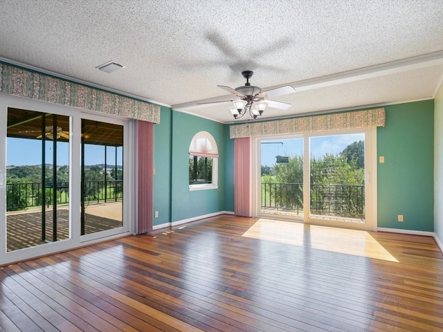 spare room with ceiling fan, hardwood / wood-style floors, and a textured ceiling