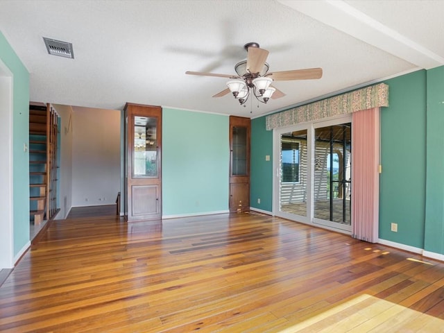 unfurnished room featuring hardwood / wood-style flooring, crown molding, and ceiling fan