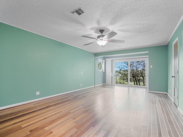 spare room with a textured ceiling, ceiling fan, and light hardwood / wood-style flooring