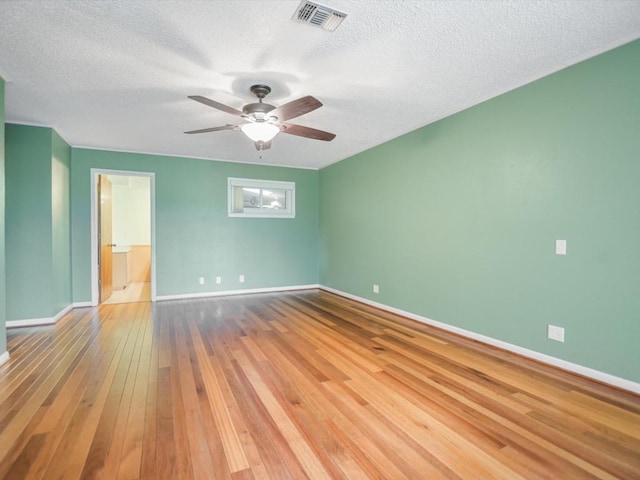 spare room with hardwood / wood-style floors, a textured ceiling, and ceiling fan