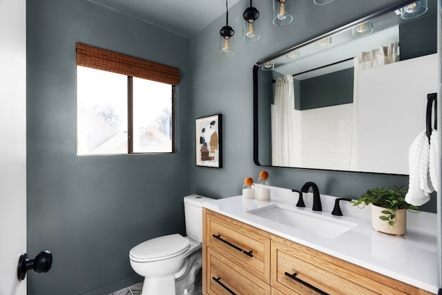 bathroom featuring vanity and toilet