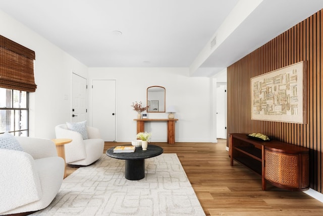 sitting room with wood-type flooring