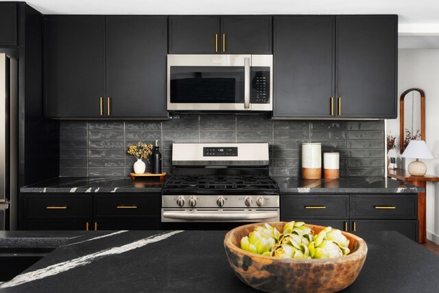 kitchen with appliances with stainless steel finishes and decorative backsplash