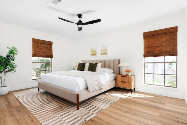 bedroom with ceiling fan and light hardwood / wood-style flooring