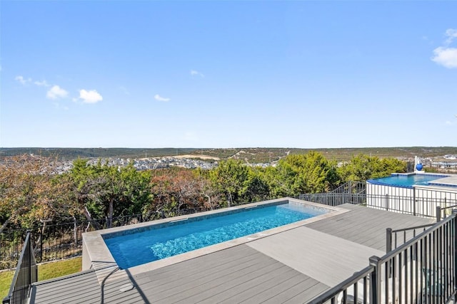 view of swimming pool featuring a wooden deck