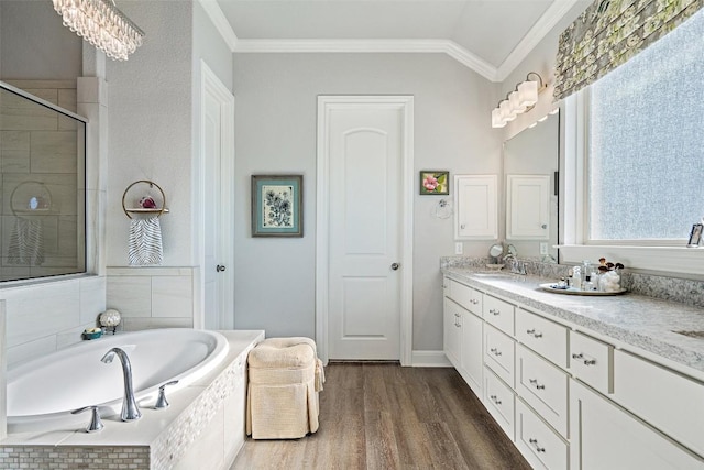 bathroom featuring lofted ceiling, hardwood / wood-style floors, crown molding, and vanity