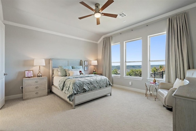 carpeted bedroom featuring crown molding, vaulted ceiling, and ceiling fan