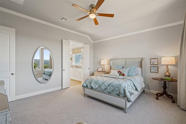 bedroom with light carpet, crown molding, vaulted ceiling, and ensuite bath