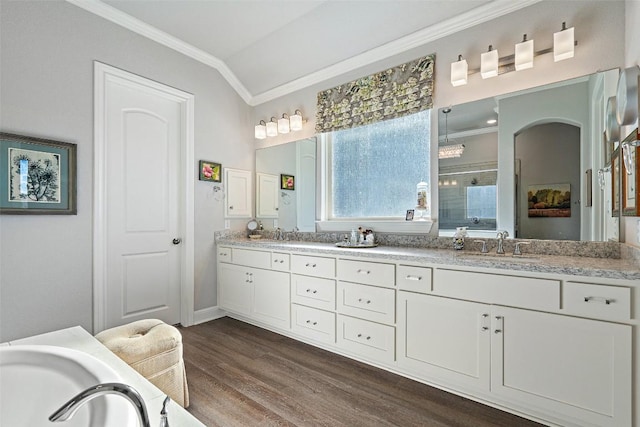 1745 Liguria Ct, Leander, TX 78641 - bathroom featuring crown molding, a shower stall, double vanity, wood finished floors, and a garden tub