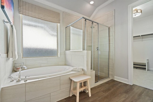 full bathroom featuring a stall shower, wood finished floors, a walk in closet, crown molding, and a bath