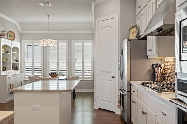 1745 Liguria Ct, Leander, TX 78641 - kitchen featuring under cabinet range hood, dark wood-style floors, crown molding, backsplash, and light countertops