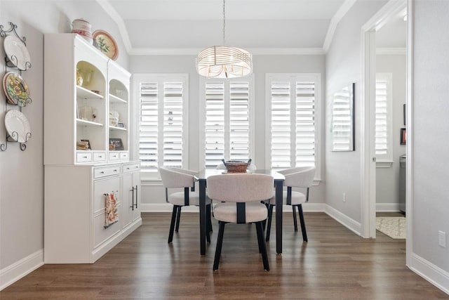 dining space featuring dark wood-type flooring and crown molding