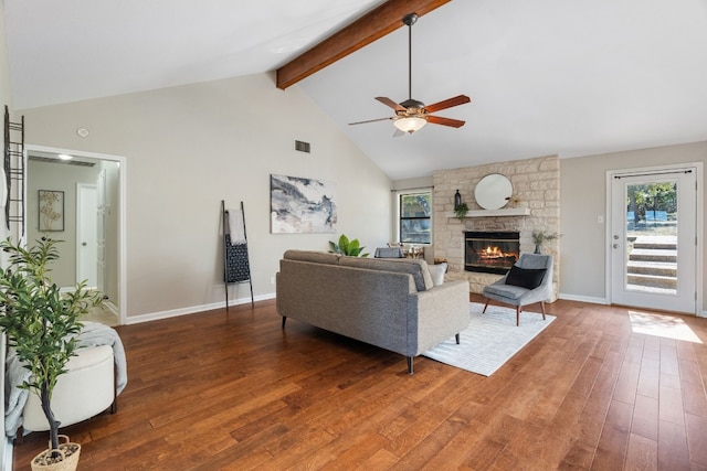 living room with high vaulted ceiling, a fireplace, beamed ceiling, dark hardwood / wood-style flooring, and ceiling fan