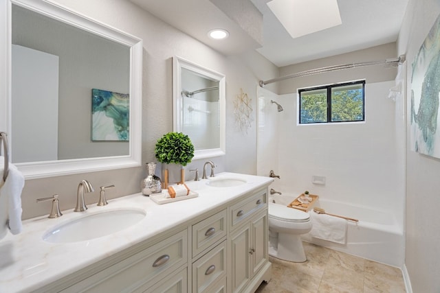 full bathroom featuring tiled shower / bath, vanity, toilet, and a skylight