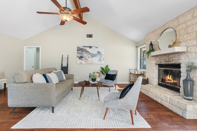 living room with dark hardwood / wood-style floors, ceiling fan, a fireplace, and high vaulted ceiling