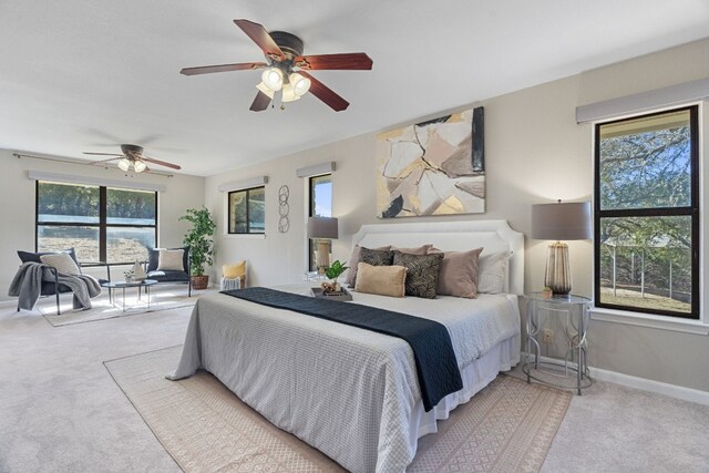 1043 Windmill Rd, Dripping Springs, TX 78620 - bedroom with carpet, baseboards, and a ceiling fan