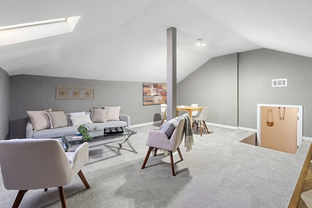 living room with lofted ceiling with skylight and carpet flooring