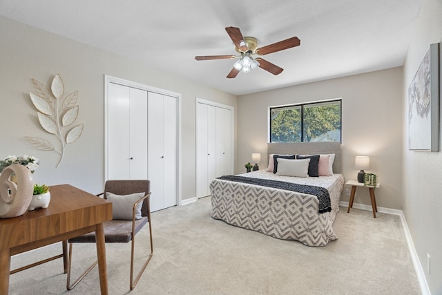 carpeted bedroom with multiple closets and ceiling fan