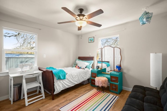 bedroom with ceiling fan and light wood-type flooring