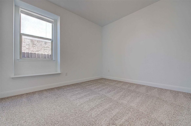 unfurnished room with vaulted ceiling and carpet