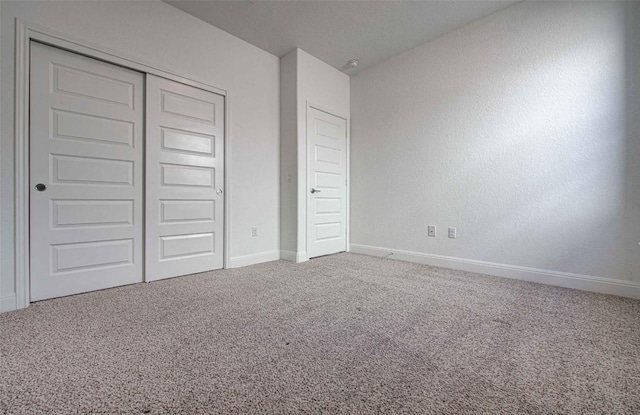 unfurnished bedroom with carpet floors and a closet