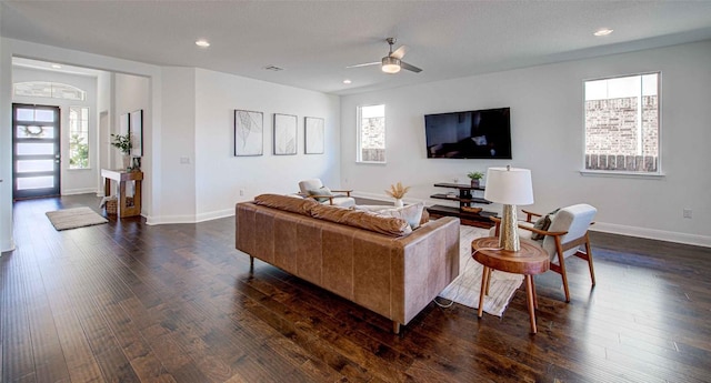 living room with dark wood-type flooring and ceiling fan