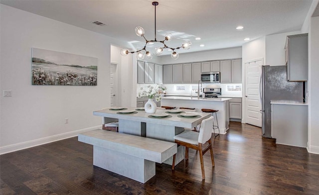 dining area featuring sink and dark hardwood / wood-style floors