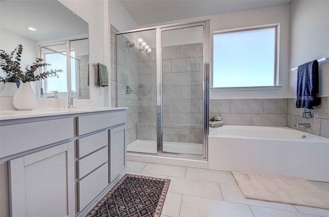 bathroom featuring vanity, tile patterned floors, and separate shower and tub