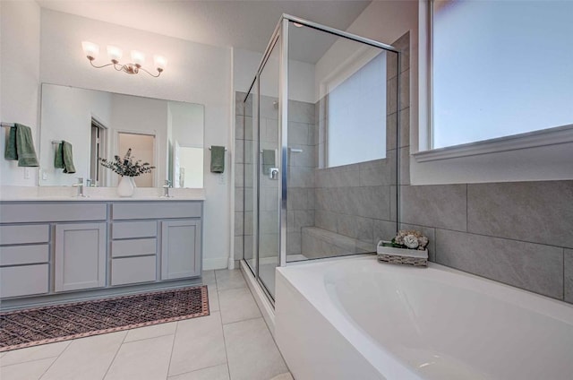 bathroom featuring vanity, tile patterned flooring, and shower with separate bathtub