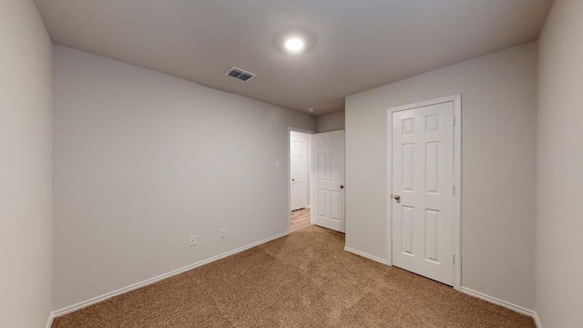 unfurnished bedroom with light colored carpet