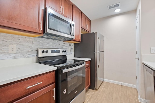 kitchen with tasteful backsplash and appliances with stainless steel finishes