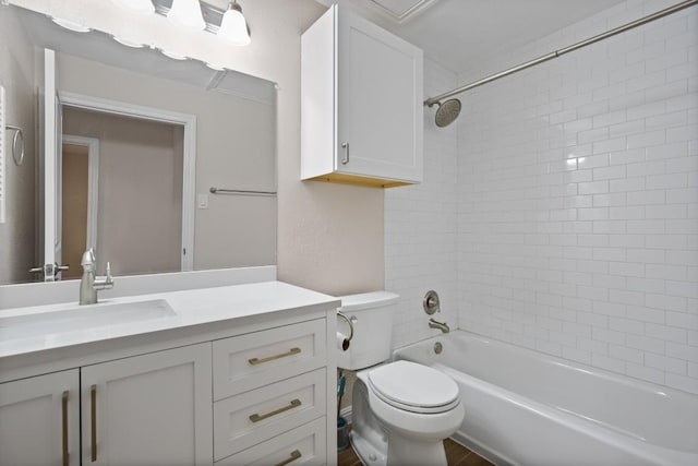 full bathroom with vanity, tiled shower / bath, and toilet