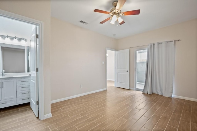 unfurnished bedroom with connected bathroom, sink, and ceiling fan