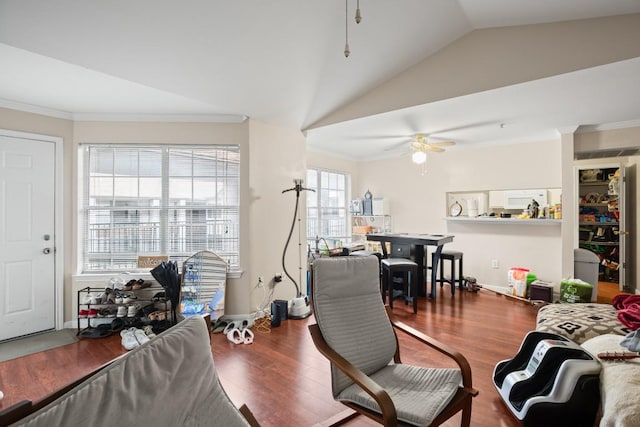 living room with wood-type flooring, vaulted ceiling, crown molding, and ceiling fan