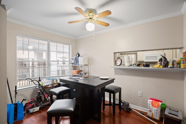 office with dark wood-type flooring, ornamental molding, and ceiling fan