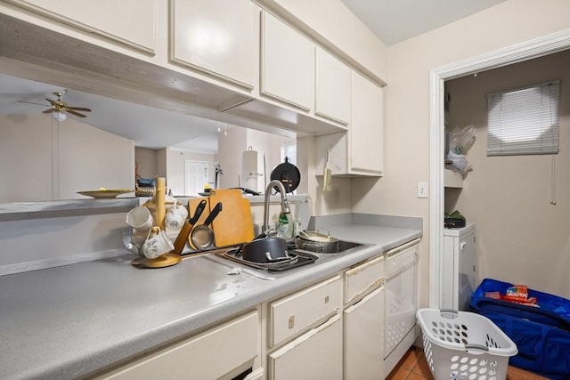 kitchen with sink, light tile patterned floors, ceiling fan, white dishwasher, and white cabinets