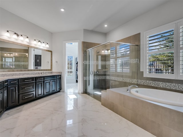 bathroom featuring vanity and separate shower and tub