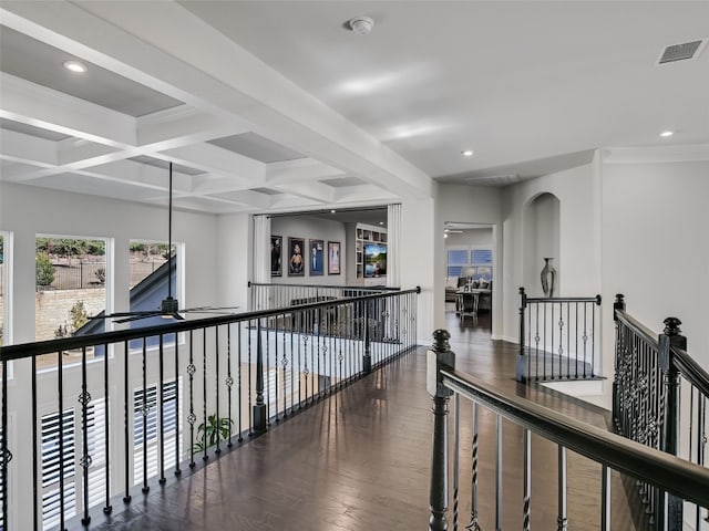 hall with coffered ceiling, ornamental molding, dark wood-type flooring, and beam ceiling