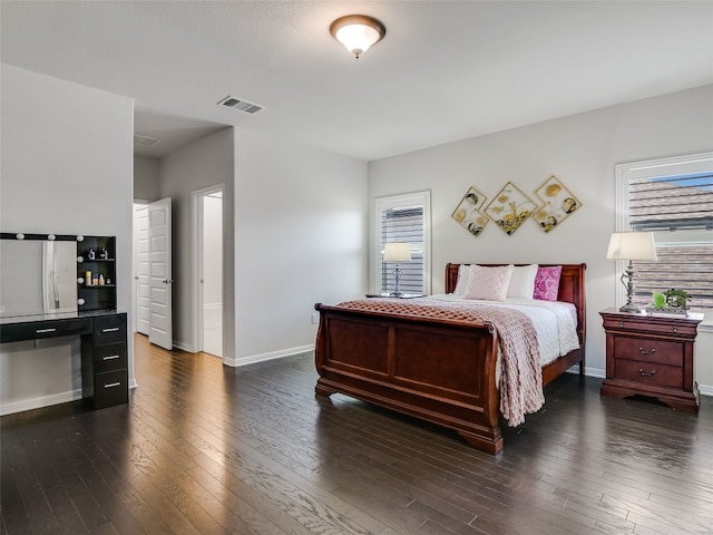 bedroom with dark hardwood / wood-style floors