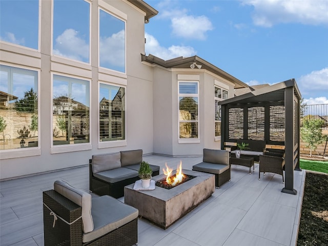 view of patio featuring an outdoor living space with a fire pit