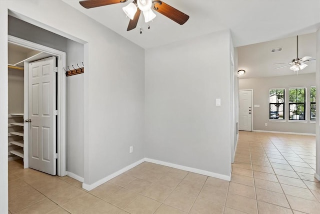 spare room with light tile patterned flooring and ceiling fan