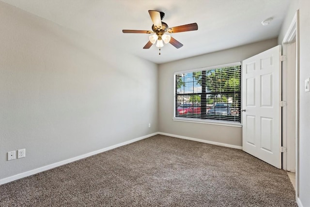 empty room with ceiling fan and carpet