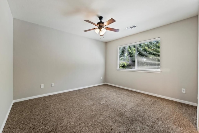 carpeted spare room featuring ceiling fan